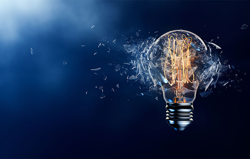 exploding light bulb on dark blue background