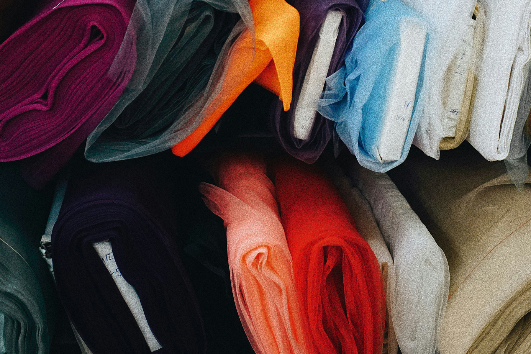 Fabric rolls for Evoralis' case study page who do enzymatic solutions for textile recycling